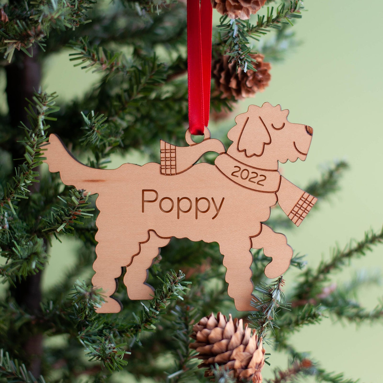 Handmade wooden dog Christmas ornament with festive details