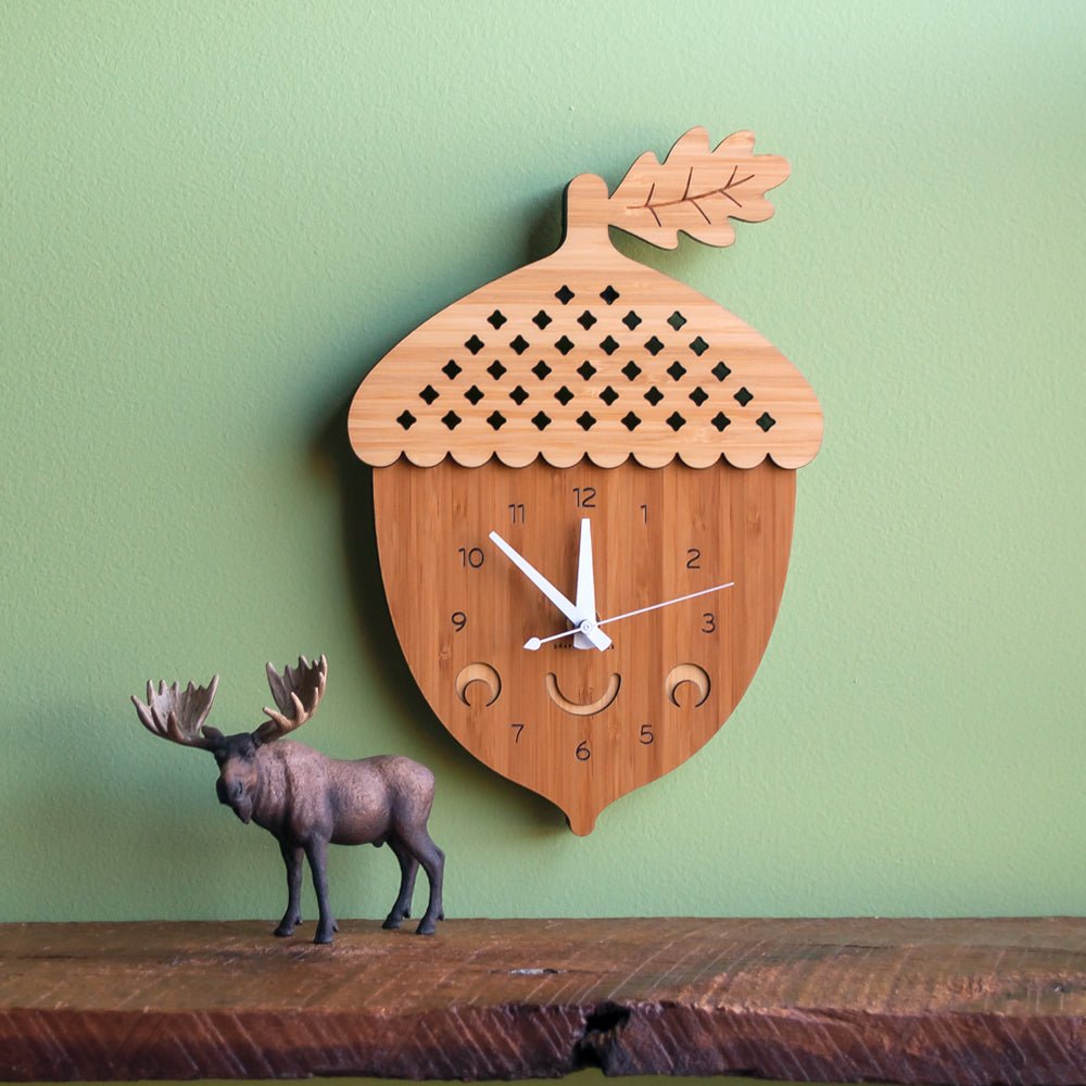Wall Clock - Acorn (Bamboo) Shown with white hands on green wall  - Handmade in TN, USA - Graphic Spaces