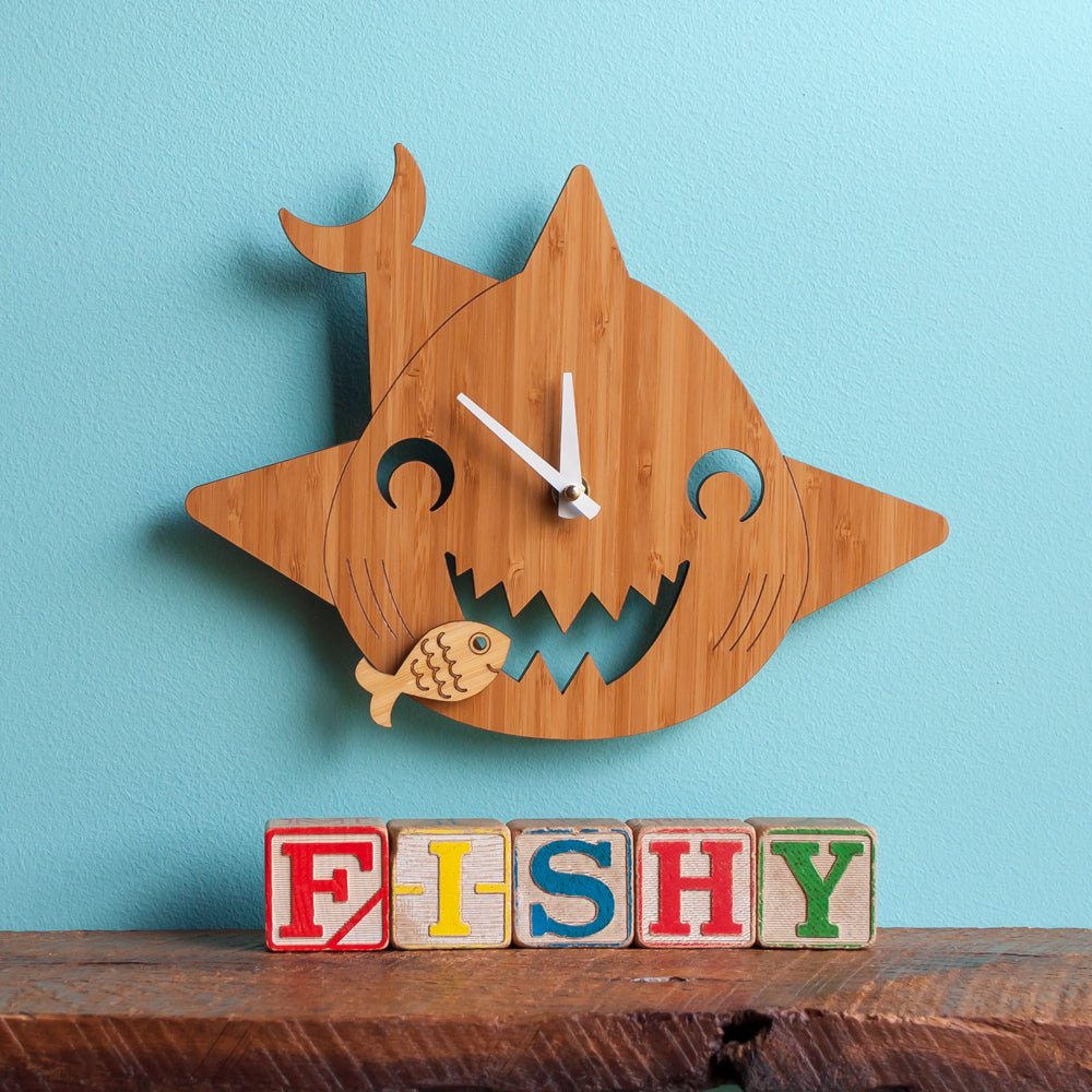 Kids Wall Clock - Shark (Wood) Cherry - Shown with white hands on blue wall  - Family Made in TN, USA - Graphic Spaces