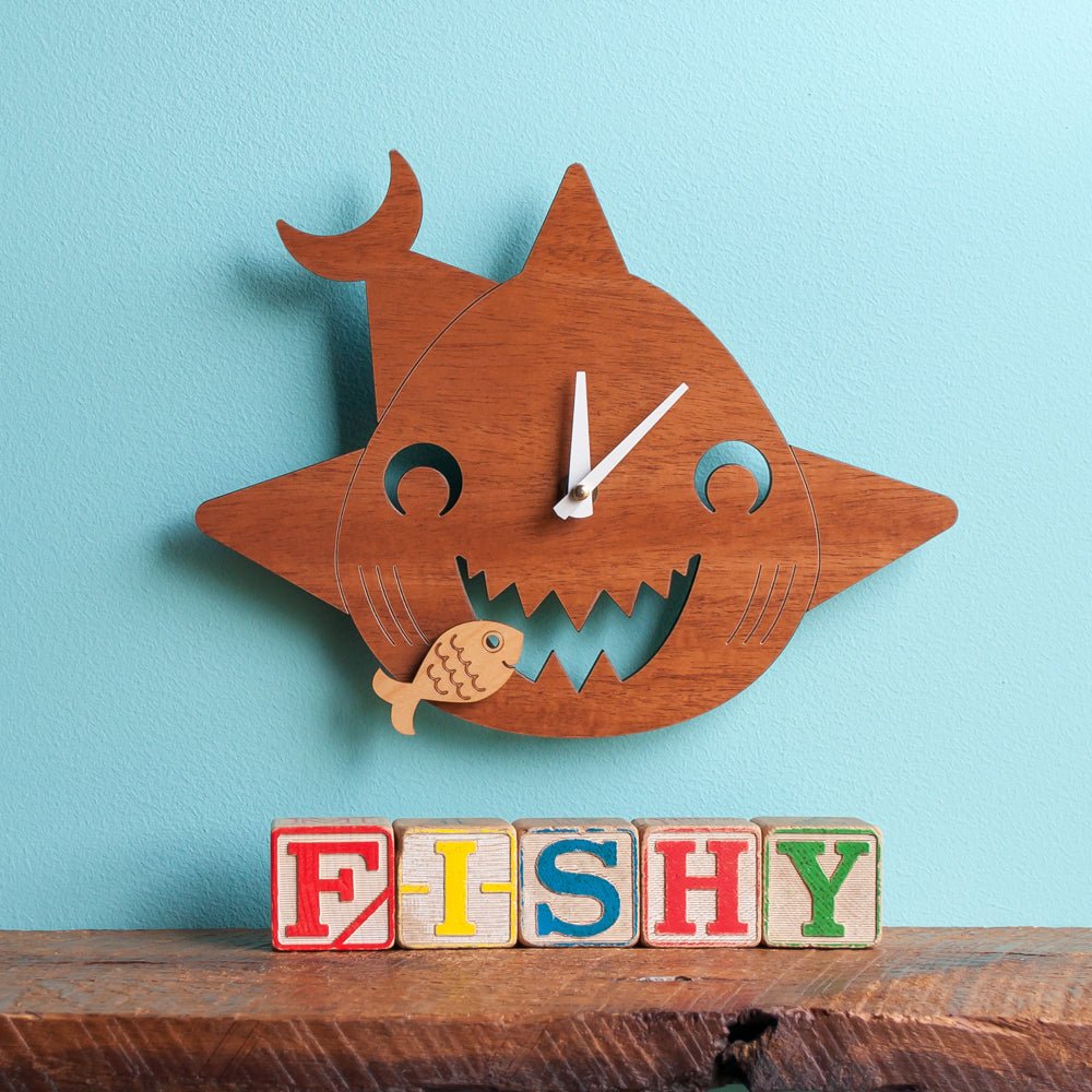 Kids Wall Clock - Shark (Wood) Cherry - Shown with white hands on blue wall  - Family Made in TN, USA - Graphic Spaces